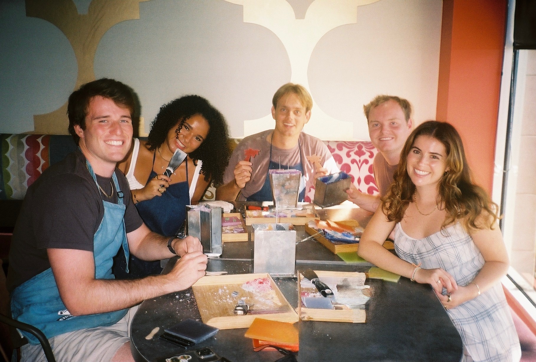 A group of friends making candles together at Glow Candle Lounge